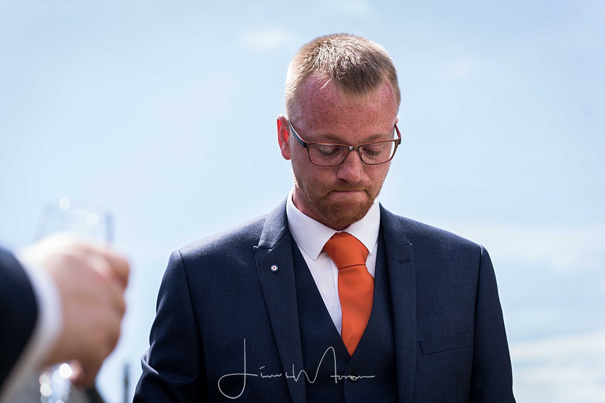 Groom reading note from bride before ceremony